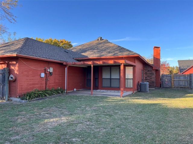 back of house with a lawn, central air condition unit, and a patio area