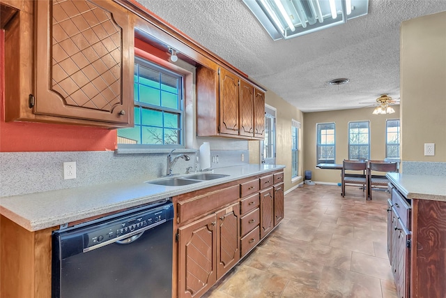 kitchen featuring ceiling fan, decorative backsplash, sink, and black dishwasher