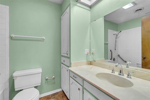 bathroom featuring toilet, vanity, and tile patterned flooring