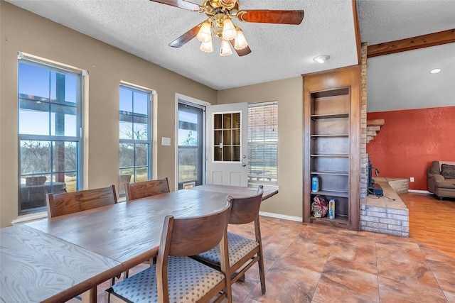 dining space featuring a textured ceiling, ceiling fan, beam ceiling, and built in shelves