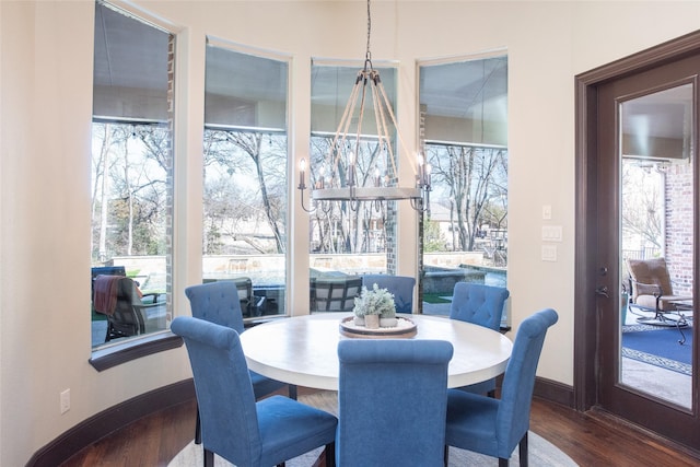 dining area featuring dark hardwood / wood-style flooring and a healthy amount of sunlight