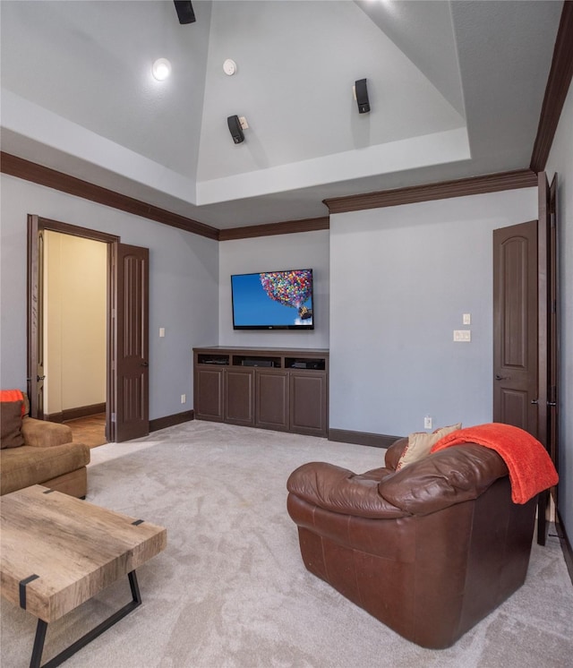 carpeted living room with crown molding, a high ceiling, and a raised ceiling