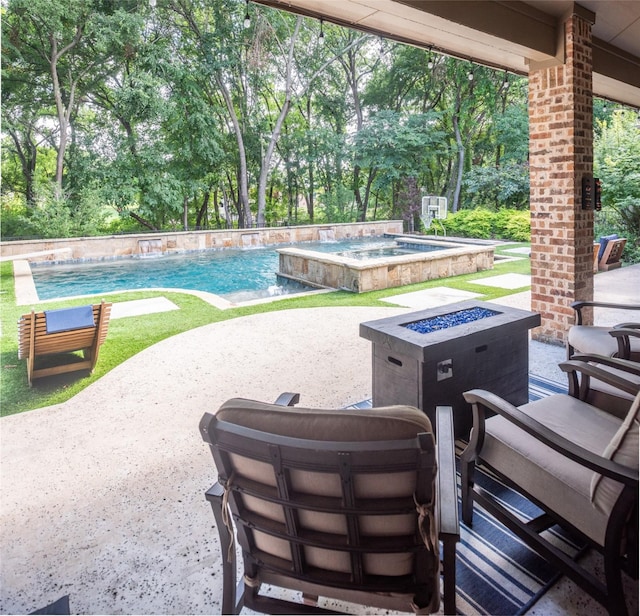 exterior space featuring pool water feature, a swimming pool with hot tub, and an outdoor fire pit