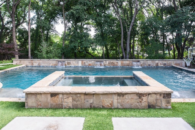 view of swimming pool with pool water feature and an in ground hot tub