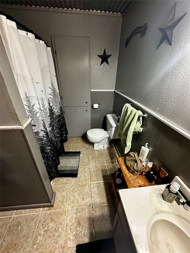 bathroom featuring tile patterned floors, vanity, toilet, and a shower with shower curtain