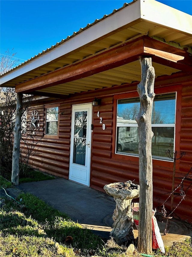 entrance to property featuring a patio