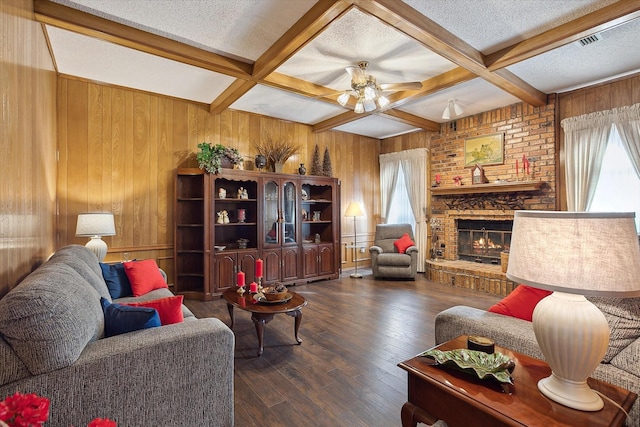 living room with a textured ceiling, beam ceiling, and coffered ceiling