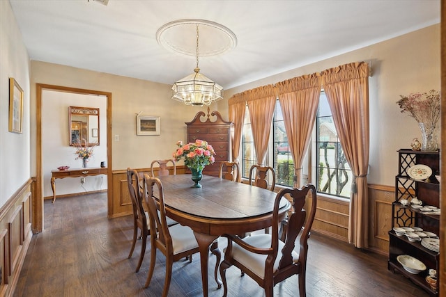 dining space featuring dark hardwood / wood-style flooring and a chandelier