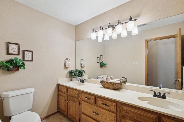 bathroom with toilet and vanity