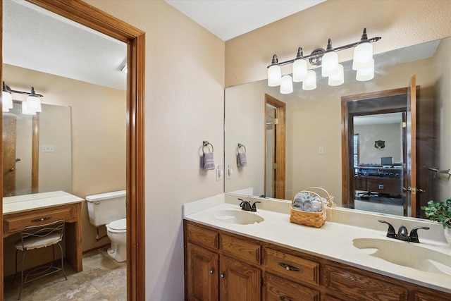 bathroom with toilet and vanity