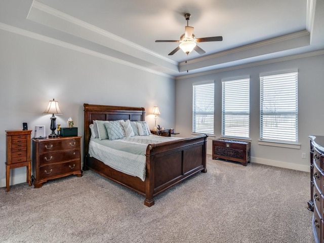 bedroom featuring ceiling fan, a raised ceiling, crown molding, and light carpet