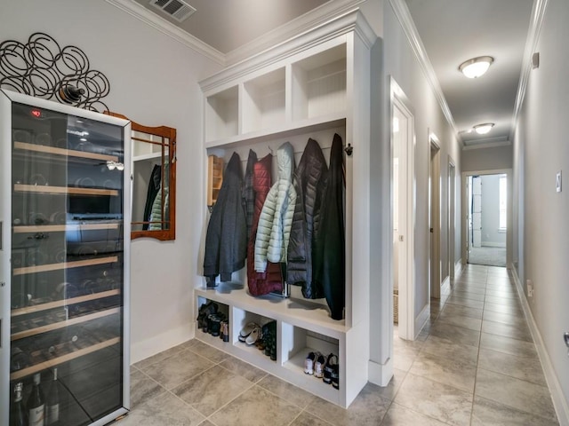 mudroom featuring beverage cooler and crown molding