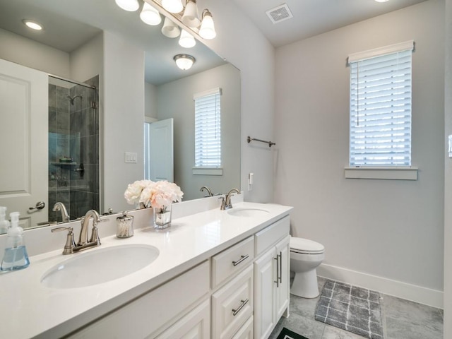 bathroom with a wealth of natural light, tile patterned flooring, vanity, and an enclosed shower