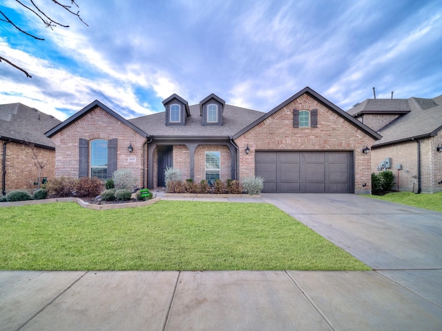 view of front of house featuring a front yard and a garage