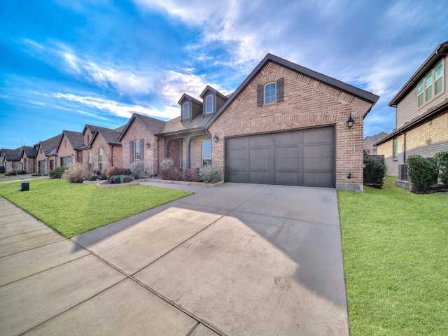 view of front of house featuring a garage, a front yard, and central AC unit