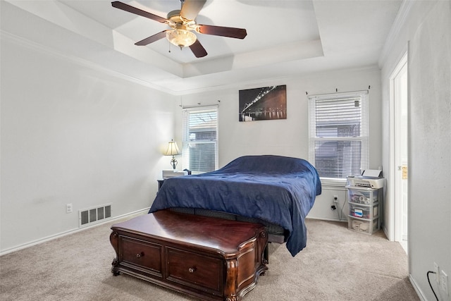 bedroom featuring ceiling fan, a raised ceiling, light carpet, and crown molding