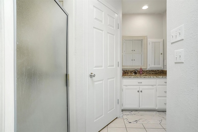 bathroom with vanity, tile patterned floors, and a shower with shower door