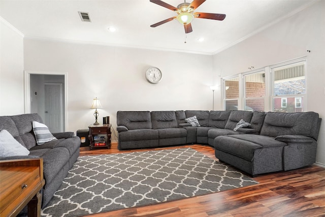 living room with dark hardwood / wood-style flooring, ceiling fan, and ornamental molding