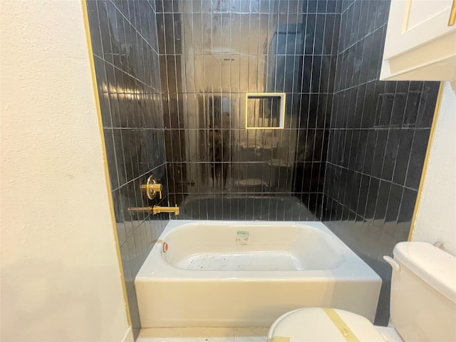 bathroom featuring tub / shower combination and toilet