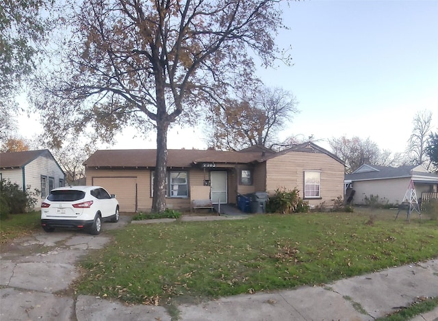 ranch-style house with a front yard and a garage