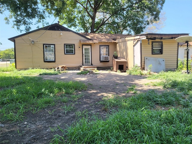 rear view of house featuring cooling unit