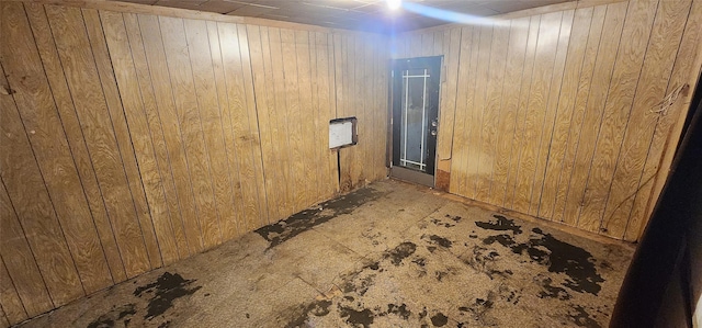 basement featuring wood walls