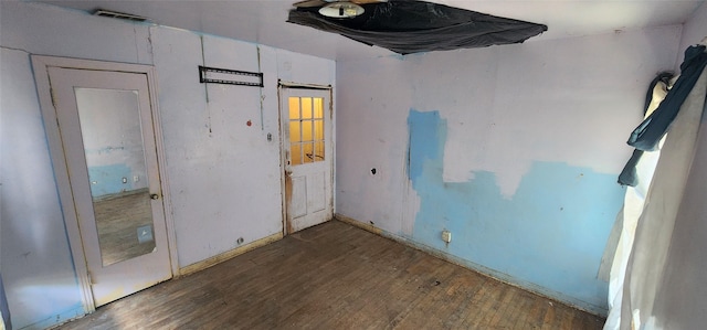 empty room featuring dark wood-type flooring