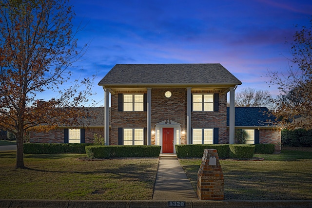 colonial inspired home with a yard