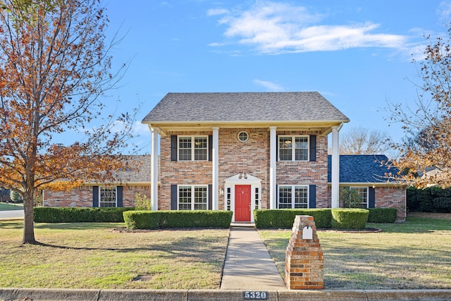 colonial home with a front lawn