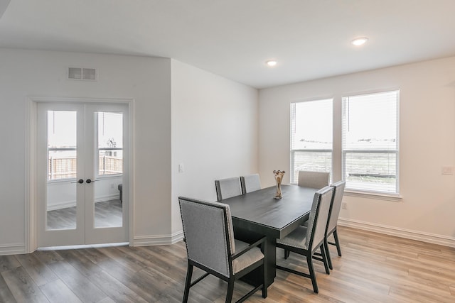 dining room featuring a wealth of natural light and hardwood / wood-style flooring