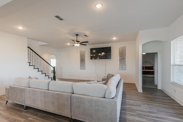 living room featuring ceiling fan and wood-type flooring