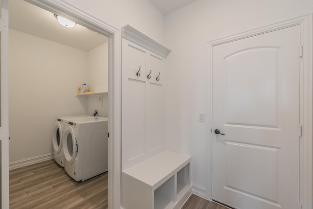 mudroom with wood-type flooring and separate washer and dryer