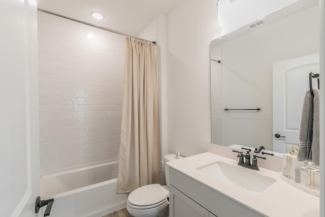 full bathroom with shower / tub combo with curtain, vanity, and toilet