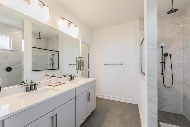 bathroom with a tile shower, tile patterned flooring, and vanity