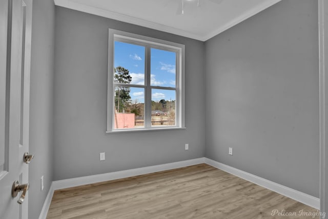 empty room featuring ceiling fan, light hardwood / wood-style flooring, and ornamental molding