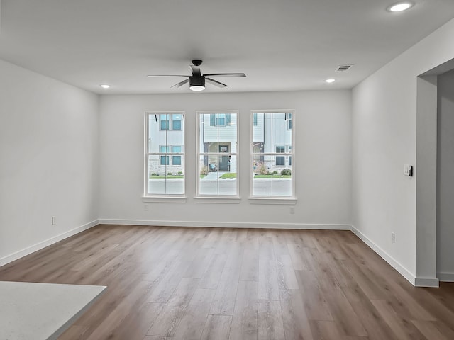 empty room featuring ceiling fan and light hardwood / wood-style floors