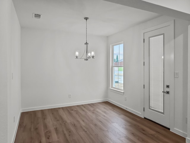 interior space featuring hardwood / wood-style floors and a notable chandelier