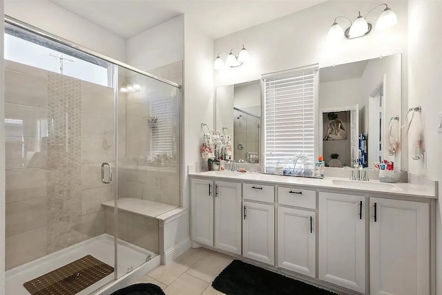 bathroom featuring tile patterned floors, vanity, and an enclosed shower