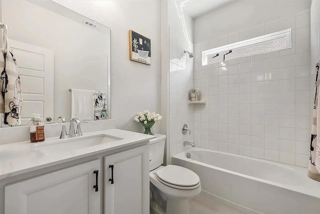 full bathroom with vanity, toilet, and tiled shower / bath combo