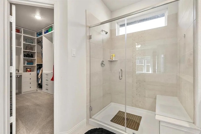 bathroom with a shower with door