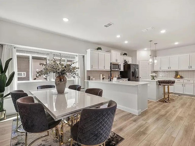 dining area with light hardwood / wood-style flooring