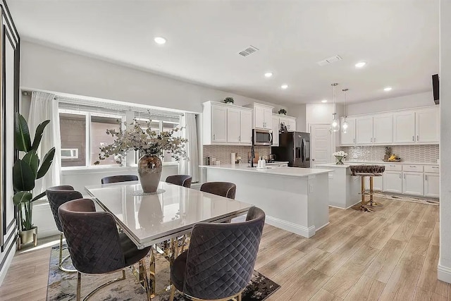 dining space with light wood-type flooring