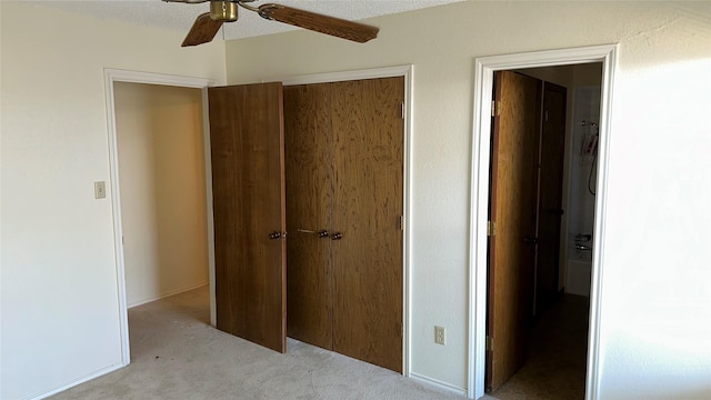 unfurnished bedroom featuring ceiling fan and light colored carpet