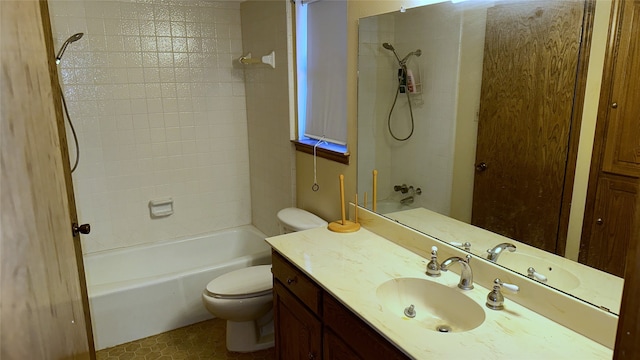 full bathroom with vanity, tiled shower / bath combo, and toilet