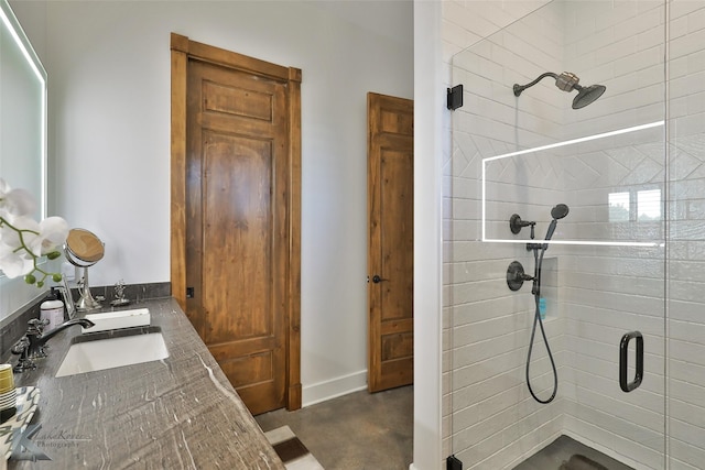 bathroom featuring sink, an enclosed shower, and concrete floors