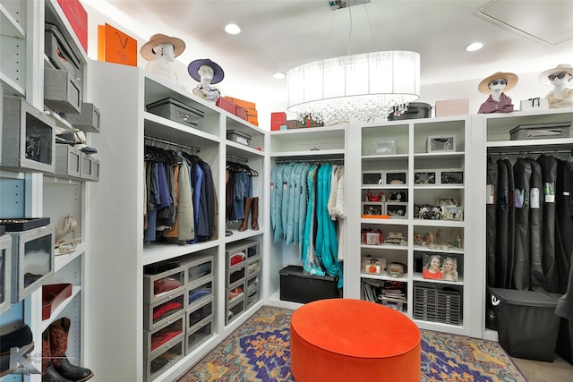 spacious closet with a chandelier