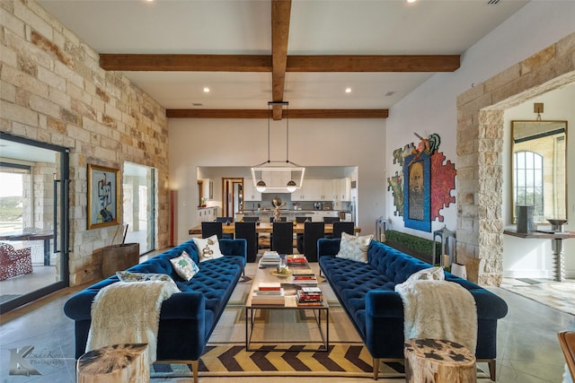 living room featuring plenty of natural light and beam ceiling