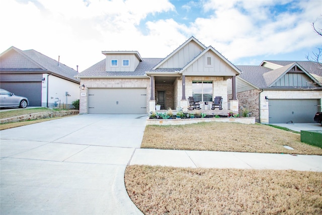 craftsman inspired home featuring covered porch and a garage