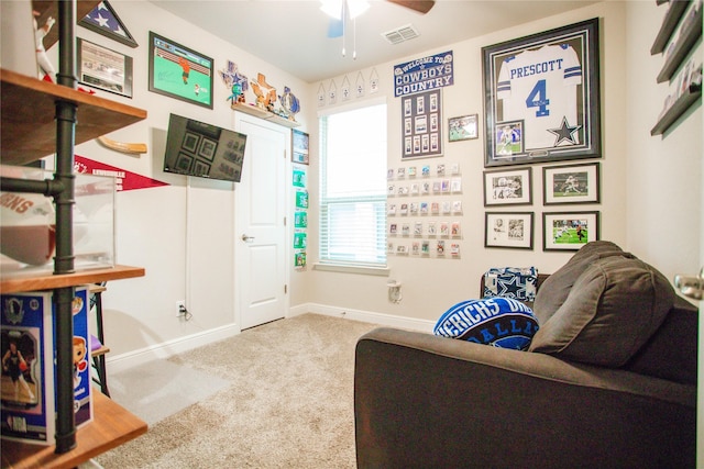 sitting room with ceiling fan and light colored carpet