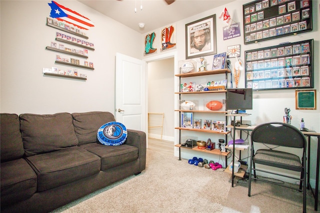 carpeted living room with ceiling fan